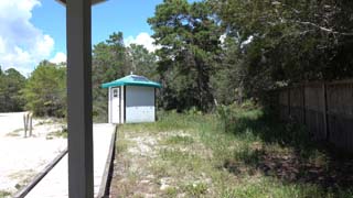 Looking north at rest room and space along fence to WaterSound